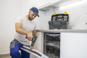 Handyman installing a dish washer